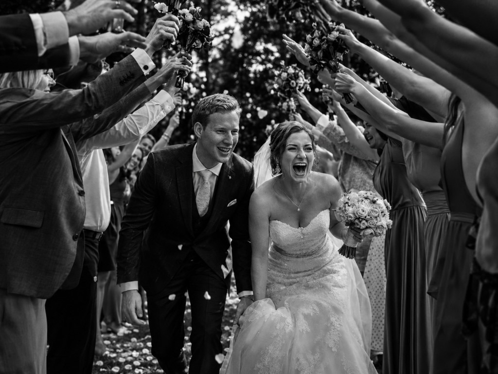 Alex and Julia running through a tunnel of guests